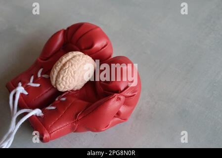 Human brain model on top of boxing gloves with copy space. Fight brain diseases concept Stock Photo