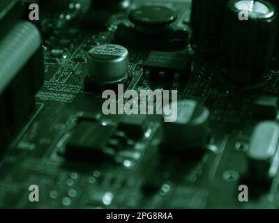 A close-up view of a complex electronic circuit board, displaying a variety of components, wires, and resistors Stock Photo