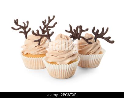Delicious Christmas cupcakes with chocolate reindeer antlers on white background Stock Photo