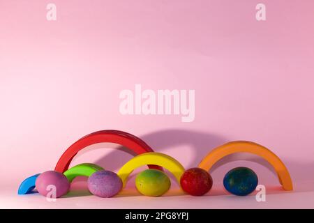 colorful Easter eggs above colorful plastic toy, creative holiday design, children toy Stock Photo