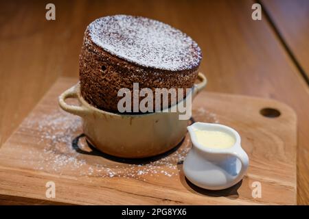 Chocolate souffle served on wooden plate Stock Photo