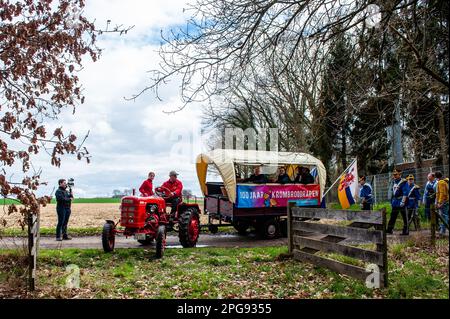 A tractor seen arriving at the top of the hill with the people that are going to be throwing the buns. Every year halfway through the fasting period, around 15,000 crescent-shaped buns of bread are thrown out from a 100 m high hill called 'Kollenberg' for the children of the city in Sittard. The distribution of bread to the poor, especially during Lent, is a tradition that goes way back. Demonstrable in Sittard until the 15th century. The foundation 'the Krombroodrapen Sittard' is celebrating its 100th anniversary this year. It's also recognized as Intangible Cultural Heritage of The Netherlan Stock Photo