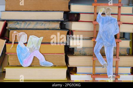 education for people of all ages,learning,knowledge,advanced training concept,books on a shelf with drawing of a girl reading a book and businessman Stock Photo