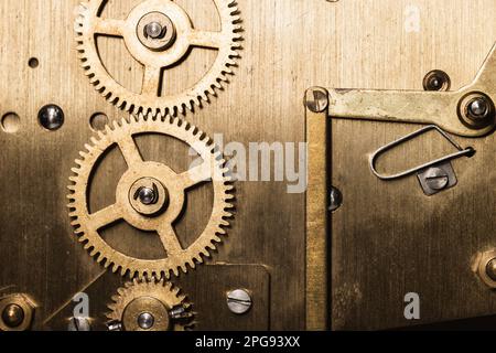 Vintage clock mechanism, close up photo of brass gears with selective focus Stock Photo