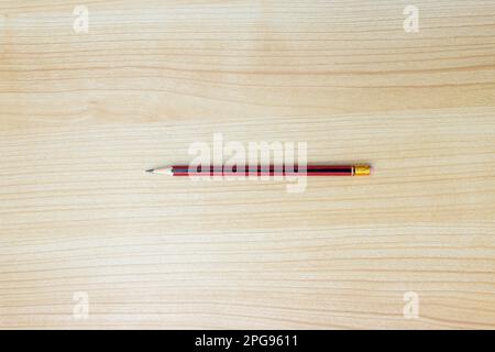 A photo of a pencil isolated on wooden background, after some edits. Stock Photo
