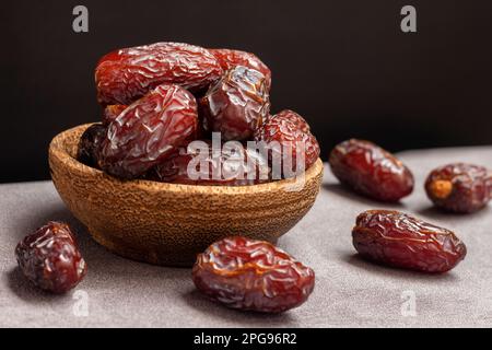 close-up Delicious dates in a wooden bowl Stock Photo