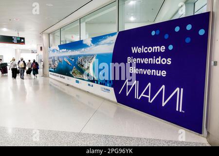 Miami Florida,MIA International Airport,terminal concourse gate area,banner welcome,man men male,woman women lady female,adult adults,resident residen Stock Photo