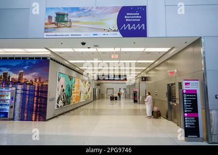 Miami Florida,MIA International Airport,terminal concourse,welcome,woman women lady female,adult adults,resident residents,inside interior indoors,two Stock Photo