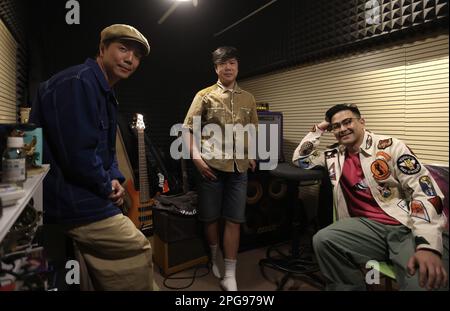 Rubberband with (L to R) bassist Lee Siu-wai, drummer Lai Man-wang, and singer Mau Hou-cheong, at their studio in Kowloon Bay.  07MAR23 SCMP / Jonathan Wong Stock Photo