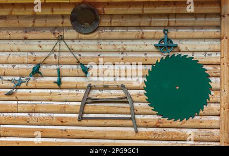 Fairbanks, Alaska, USA - July 27, 2011: Pike's Waterfront lodges. Clumberejack tools hanging on brown wooden wall Stock Photo