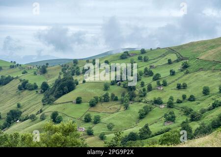 Rustic stone shepherds cabins in a hill with green meadows Stock Photo