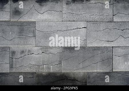 Wall surface with polished grey volcanic basalt stone slabs veneer Stock Photo