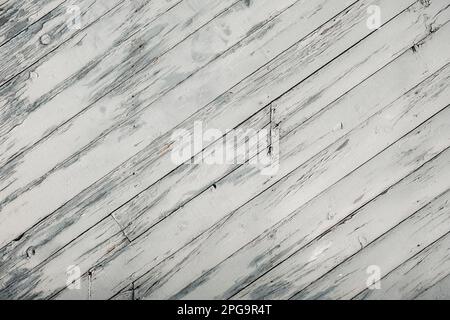 Old white painted wooden wall with diagonal strips, rustic background Stock Photo