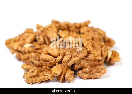 Cracked walnuts against white background Stock Photo