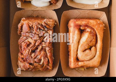 Pecan cinnamon roll, and Original cinnamon roll close up, flat lay Stock Photo