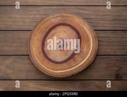 Empty rustic wooden board over wooden table. Stock Photo