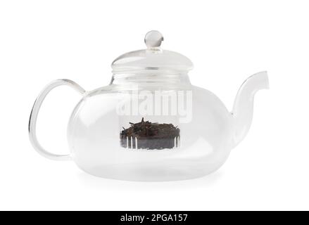 Empty glass transparent teapot and dry green tea in it on a white background. Utensils for making tea. Stock Photo