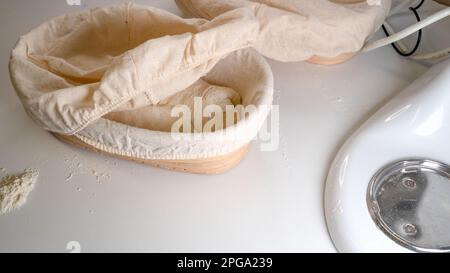 Proofing basket, bannetons bread score on white table, sourdough bread, top side view Stock Photo