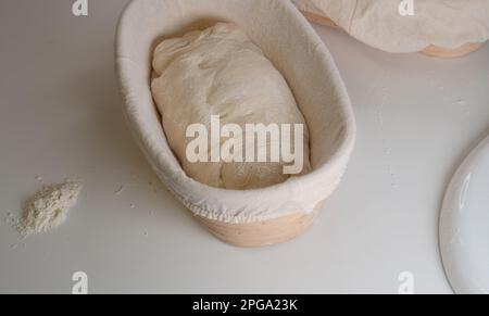 Proofing basket, bannetons bread score on white table, sourdough bread, top side view Stock Photo