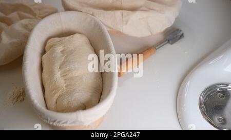 Proofing basket, bannetons bread score on white table, sourdough bread, top side view Stock Photo