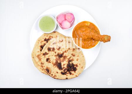 Top view of butter chicken with tandoori chapati in plate isolated on white background Stock Photo