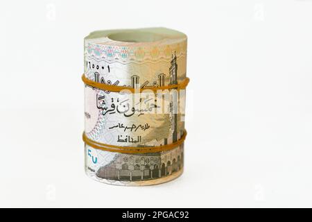 50 Piasters Half EGP LE Egyptian pound cash money bills rolled up with rubber bands with a image of Al Azhar mosque and Ramesses II the second 2nd, Eg Stock Photo