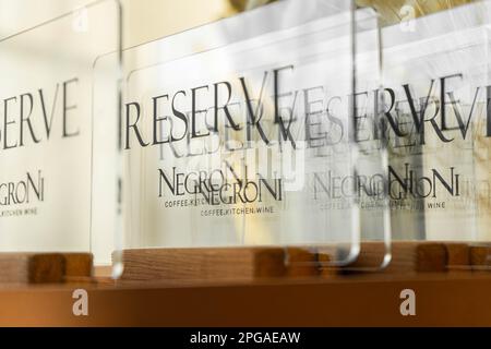 A close-up shot of a restaurant reservation stand with a bold, black-letter announcement Stock Photo