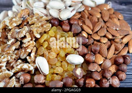 Mixture of various types of nuts, Pistachios, hazelnuts, almonds, walnuts, raisins that used in baking and desserts and could be eaten raw, contain vi Stock Photo