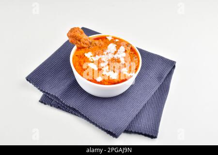 Bowl of creamy butter chicken isolated on white background Stock Photo