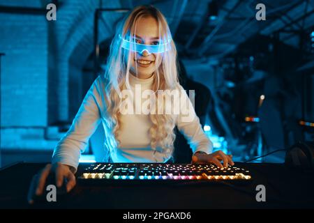 A blonde is playing PC games. Cyberpunk neon style. Stock Photo