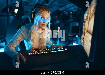 A blonde is playing PC games. Cyberpunk neon style. Stock Photo