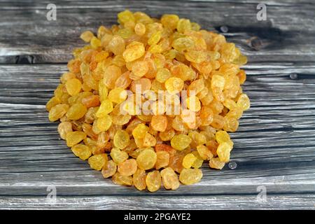 Pile of raisins, a dried grape, raisins are produced in many regions of the world and may be eaten raw or used in cooking, baking, and brewing, also c Stock Photo