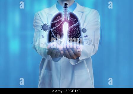 Doctor demonstrating digital image of human lungs affected by virus on blue background, closeup Stock Photo