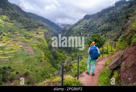 Hiker on Levada do Moinho, Ponta do Sol, Madeira, Portugal Stock Photo