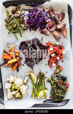Various roasted and steamed vegetables with assorted toppings. Stock Photo