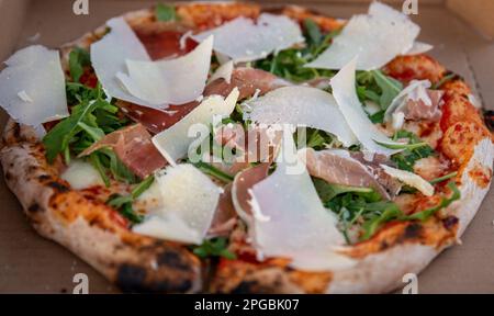 Freshly made Prosciutto Arugula and Parmesan Pizza Stock Photo