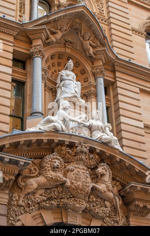 Looking up at the UK coat of arms and the marble statue of Queen Victoria on the GPO in Sydney, Australia that was built in stages from 1866 to 1891 Stock Photo
