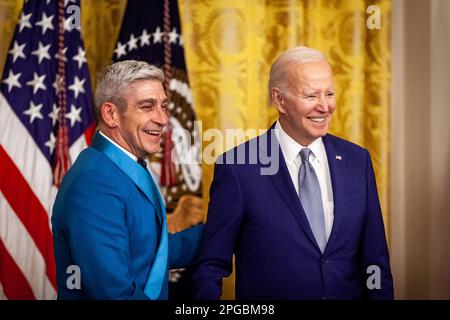Washington, United States. 21st Mar, 2023. President Joe Biden awards poet Richard Blanco the National Humanities Medal during a White House ceremony presenting arts and humanities medals to 23 individuals. The event honored the 2021 recipients of the medals. The original award ceremony was postponed due to the coronavirus pandemic. Both medals are the highest honors given by the US government in the arts and humanities. (Photo by Allison Bailey/NurPhoto) Credit: NurPhoto SRL/Alamy Live News Stock Photo