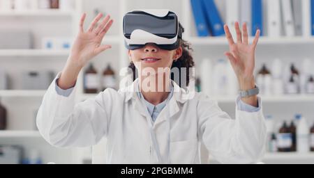 Its a whole new world to discover. a young scientist wearing a VR headset in a lab. Stock Photo