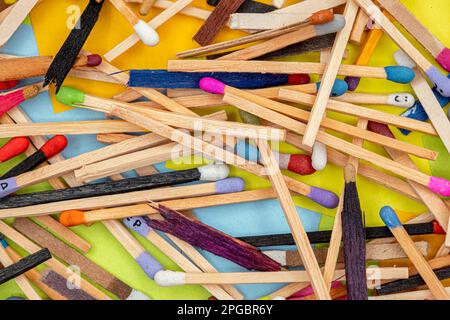 matchsticks of various shapes and colors with multicolored paper sticky notes on background Stock Photo