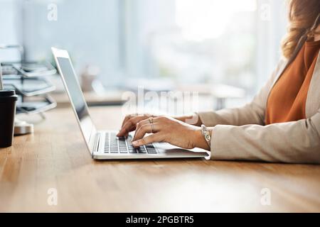 Working hard is second nature to her. an unrecognizable businesswoman working on a laptop on her office. Stock Photo