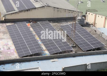 Solar panels on roof top of an old building showing the concept of adapting eco-friendly energy resources Stock Photo