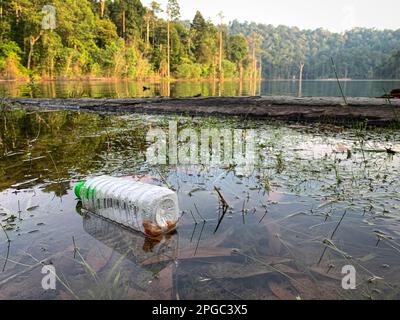 Plastic bottle floating on a lake. Plastic pollution concept. Stock Photo