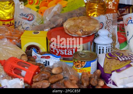 Cairo, Egypt, March 12 2023: Essential and basic food supplies oil, ghee, sugar, lentil, fava beans, rice, macaroni, salt, tea and Ramadan month Yamis Stock Photo