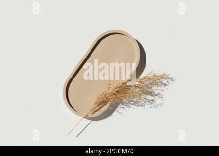 Podium for cosmetic product presentation. Abstract minimal geometrical form on white background. Oval stone form, shadow. Scene, Showcase, display. Mi Stock Photo