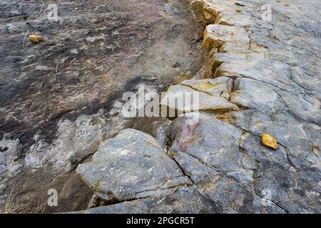 Top view of rough landscape with uneven surface and stones with black dry ash in Tabernas desert of Almeria Stock Photo