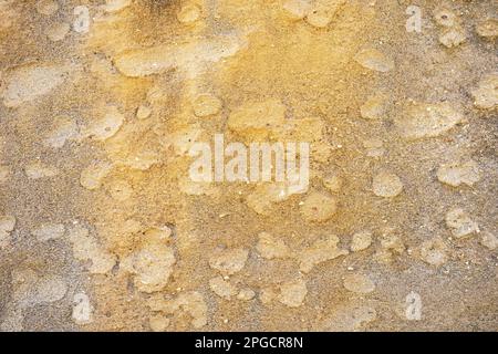 From above of textured background of rough dry grey patched sandy desert land in bright daylight Stock Photo