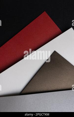 From above layout of pastel glitter cardboard sheets in brown, white, red and grey shiny shades Stock Photo