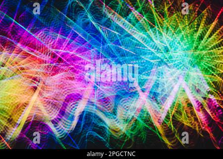 Curvy trails of bright multicolored light on black background Stock Photo