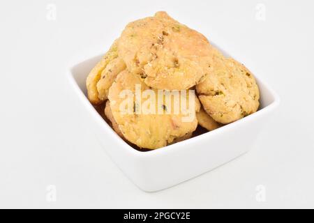 Mathri in bowl isolated on white background, indian snack methi mathri Stock Photo